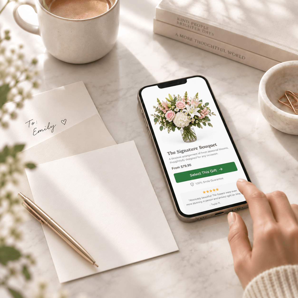 Phone displaying a Lovingly Shop bouquet page beside a handwritten card.